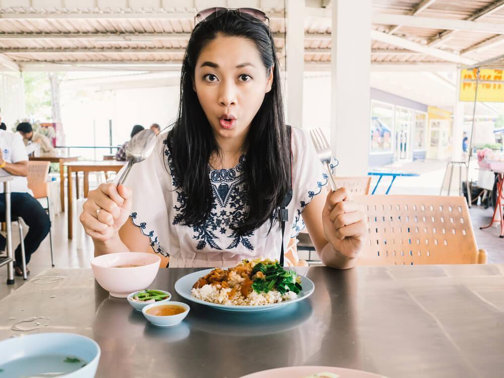 Surprised woman eating a meal