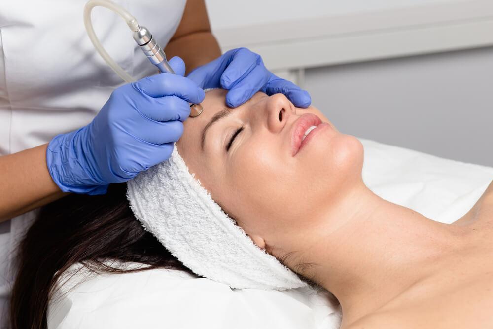 Woman undergoing microdermabrasion treatment