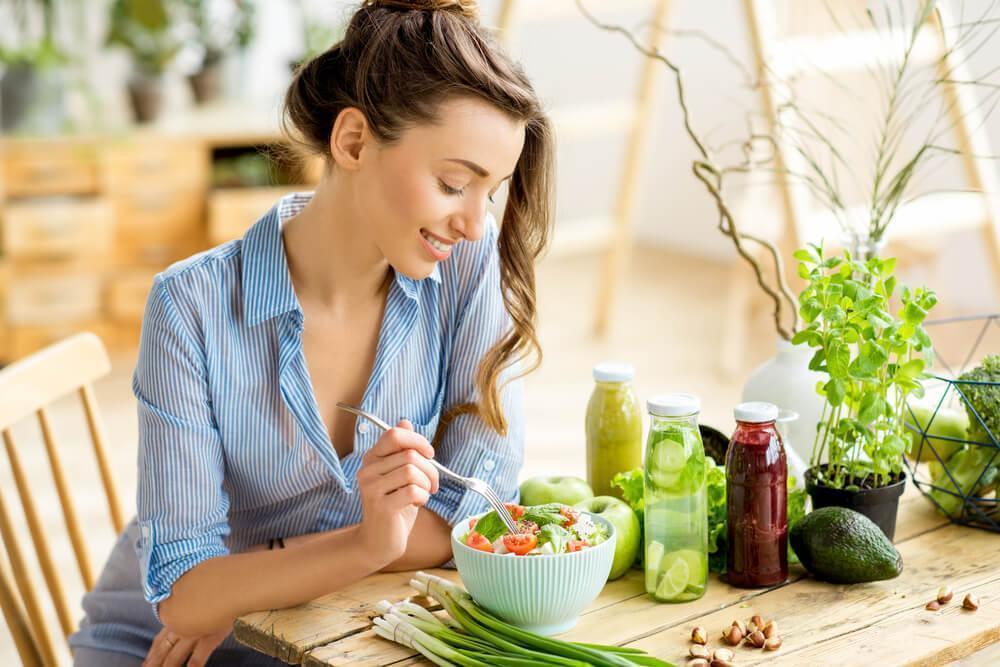 Woman eating healthy food at table