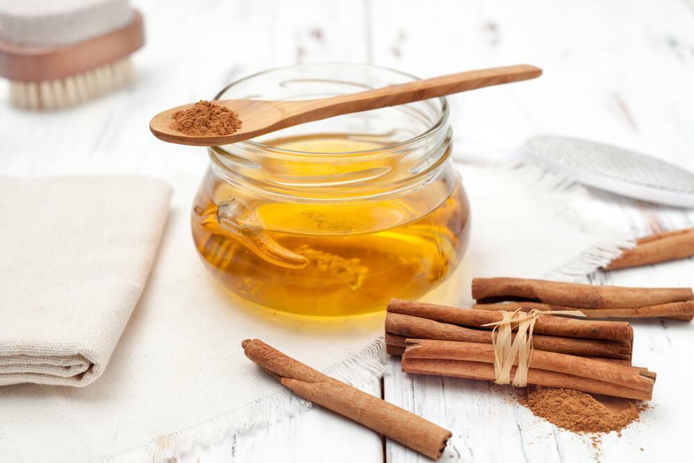 Honey in jar with cinnamon sticks