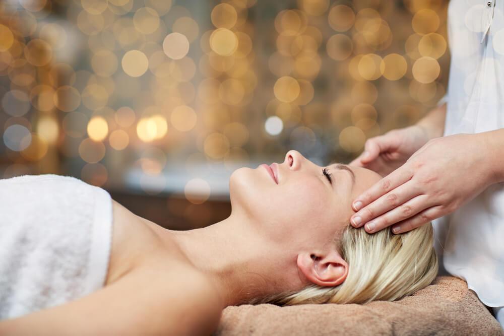 Woman at spa having face massage