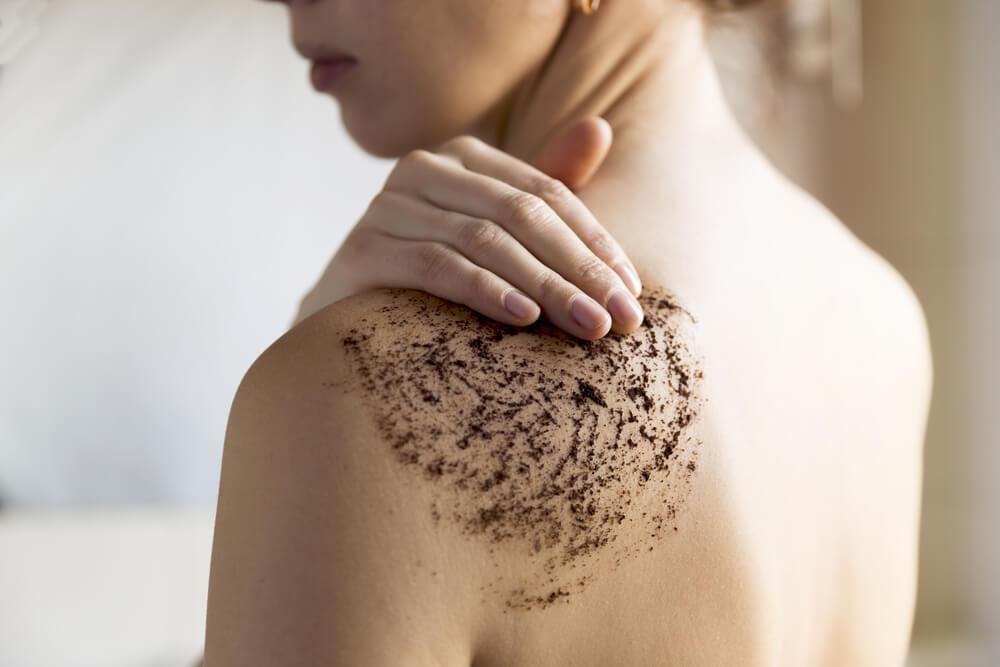 Woman using coffee scrub