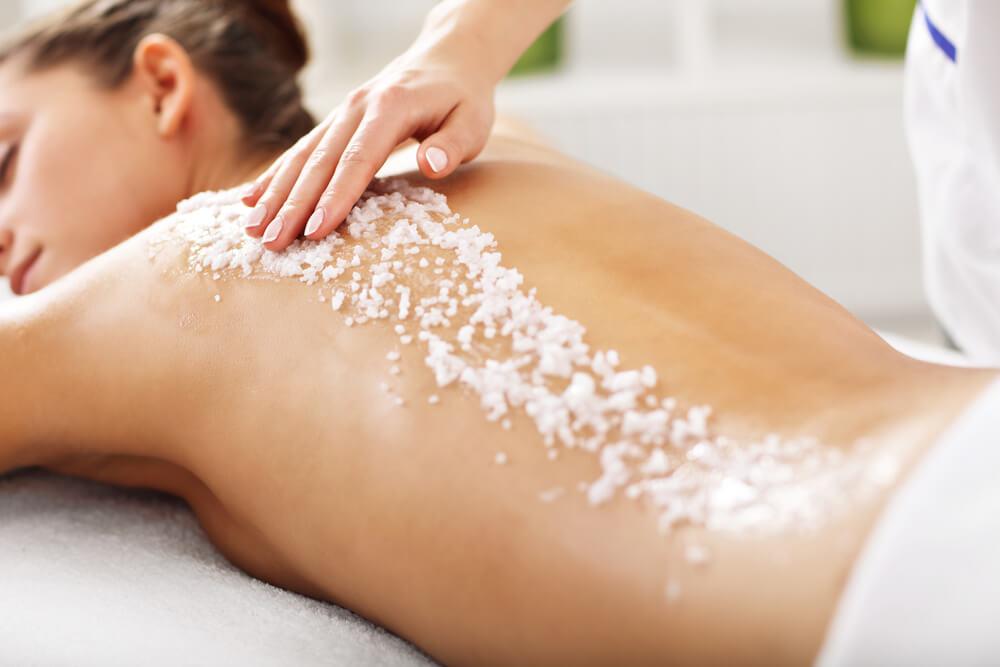 Sugar scrub on woman's back