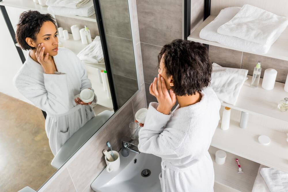 Woman applying moisturizer