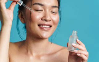 Woman micro dosing skincare serums