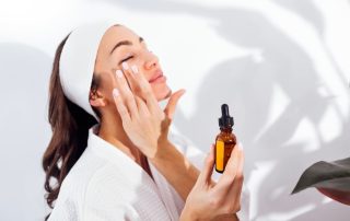 Woman patting serum into skin, showing how to apply high-end skincare correctly