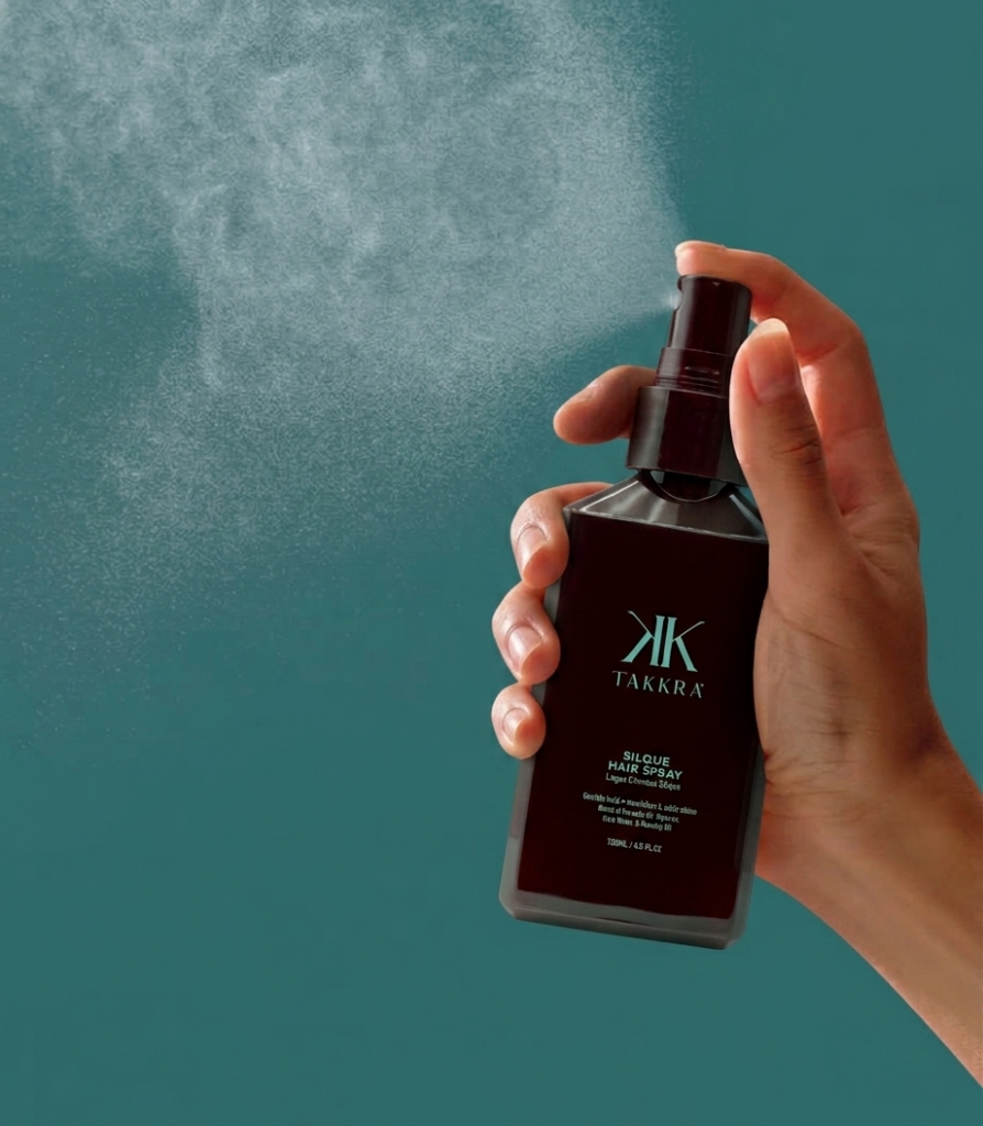 Takkra hairspray being sprayed into the air